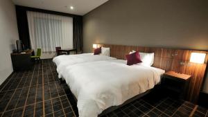 Postel nebo postele na pokoji v ubytování JR-East Hotel Mets Utsunomiya