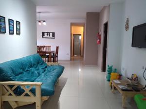 a living room with a blue couch and a table at Quincho Roca Plottier in Plottier