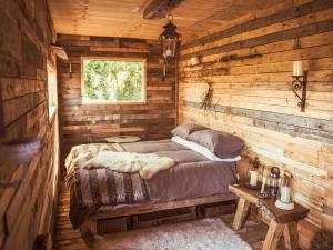 a bedroom with a bed in a log cabin at The Mamgu Lodge in Mochdre