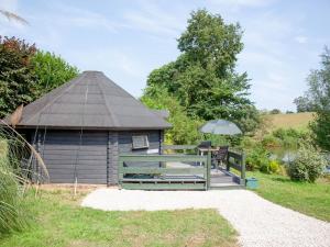 a gazebo with a table and an umbrella at Coot Roundhouse - Uk33890 in Cullompton