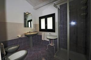 a bathroom with two toilets and a sink and a shower at Casale Laurus in Locogrande +58 photos