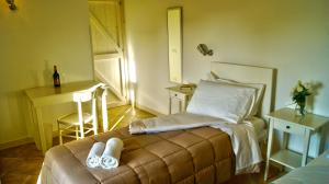 a bedroom with a bed with two slippers on it at Casale Laurus in Locogrande