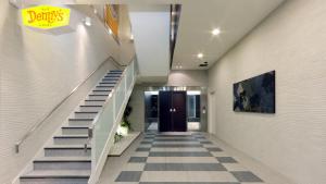 a hallway with stairs leading to a door at JR-East Hotel Mets Komagome in Tokyo