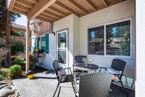 a patio with chairs and a table and a window at Walk to Downtown * 6 Guests * Pets * A/C! * No Stairs! in Leavenworth