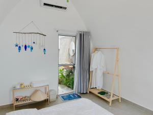 a dressing room with a mirror and a closet at Malis Homestay in Trà Vinh