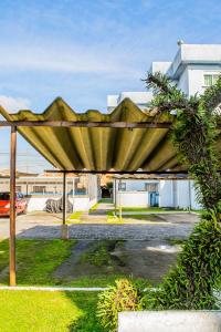 a wooden shelter in a yard with a building at Apartamento Central - Shopping-Carrefour-Universidade in Pelotas
