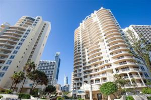 two tall white buildings in a city with palm trees at Stunning 2 bedroom Ocean View Apartment in Gold Coast