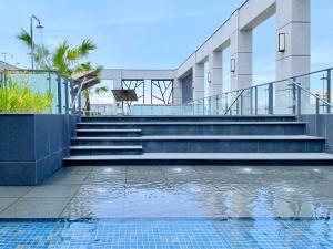 a building with stairs and a swimming pool at Grand Banyan Hotel in Tainan