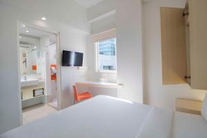 מיטה או מיטות בחדר ב-Cleo Hotel Basuki Rahmat