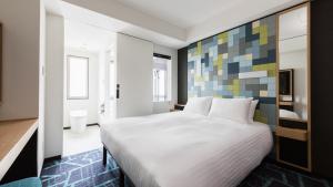 Postel nebo postele na pokoji v ubytování JR East Hotel Mets Premier Akihabara