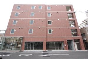 a tall red brick building on the corner of a street at Regariain - Vacation STAY 84627 in Okayama