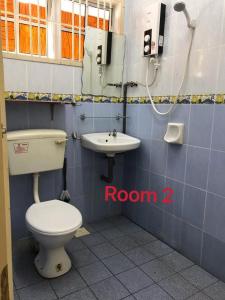 a bathroom with a toilet and a sink at 66 Semi-D Homestay in Teluk Intan