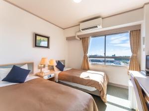 Postel nebo postele na pokoji v ubytování Tabist Hotel Ginga Kisarazu
