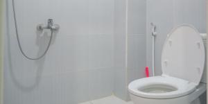 a white bathroom with a shower with a toilet at Citra Green House Syariah near Universitas Tulungagung in Tulungagung +12 photos