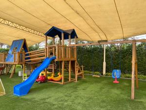 a playground under a tent with a slide at Kuyayky Lodge in Lima