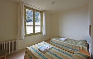 Cama o camas de una habitación en Apartamentos Montserrat Abat Marcet