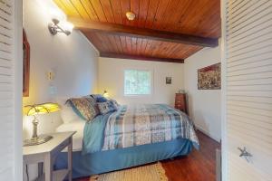 a bedroom with a bed and a table and a desk at Bay Bliss #2 in Reedsport