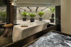 a bathroom with a large tub with flowers in it at Grand Hyatt Hong Kong in Hong Kong