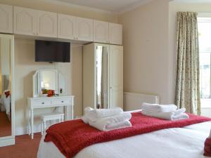 a bedroom with a bed with towels on it at Sea The Stars in Hornsea