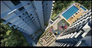 an overhead view of two tall buildings and a swimming pool at Sekinchan High Level SeaView Homestay in Sekincan