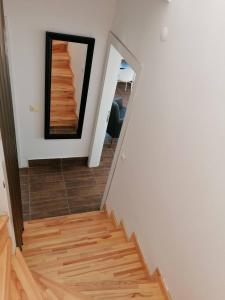 a stairwell with a mirror and a wooden floor at Private villa with pool and sauna in Altınkum