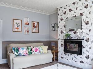 a living room with a couch and a fireplace at Chaseley House in Blackpool