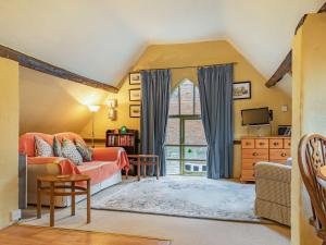 a living room with a couch and a window at The Saddlery in Shirley