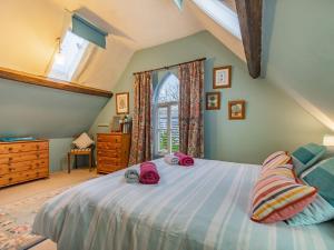 a bedroom with a large bed and a window at The Saddlery in Shirley