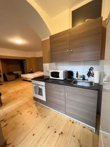 a kitchen with a sink and a microwave at Thomas Apartments in Berlin