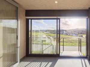 a large glass door in a room with a balcony at Luxurious 2 bedroom apartment Free secure parking in Auckland