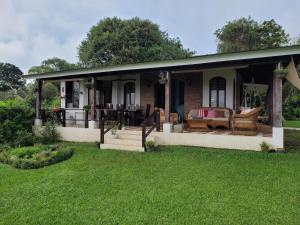 a house with a patio and a yard at Casa Vista del Valle in Jesus