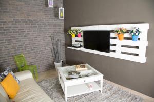a living room with a tv on a wall at Stella Maris Case Vacanze in Balestrate