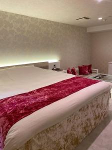 Rúm í herbergi á Hotel Regent (Adult Only)
