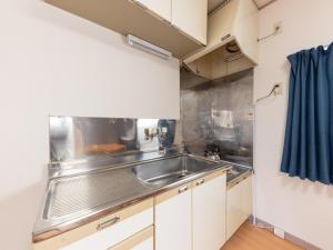 a small kitchen with a stainless steel sink at Tabist My Room Tagajjo in Tagajo