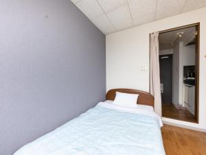 Postel nebo postele na pokoji v ubytování Tabist My Room Tagajjo