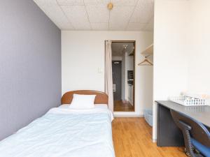 Postel nebo postele na pokoji v ubytování Tabist My Room Tagajjo