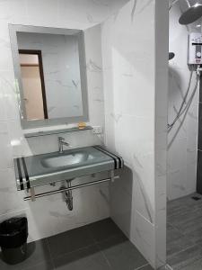 a bathroom with a sink and a mirror at Parada Place in Khon Kaen