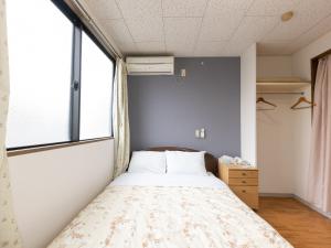 Postel nebo postele na pokoji v ubytování Tabist My Room Tagajjo