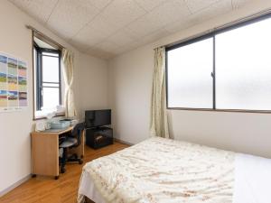Postel nebo postele na pokoji v ubytování Tabist My Room Tagajjo