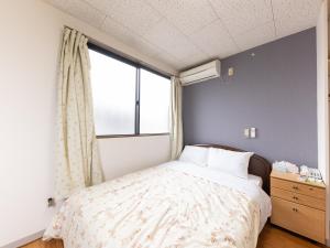 Postel nebo postele na pokoji v ubytování Tabist My Room Tagajjo