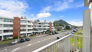 a view of a city street with cars parked at Mount Apartment - Mt Maunganui Holiday Apartment in Mount Maunganui