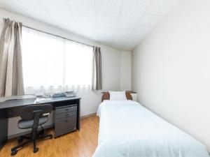 Postel nebo postele na pokoji v ubytování Tabist My Room Tagajjo
