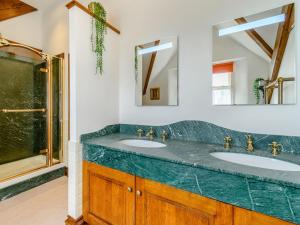 a bathroom with two sinks and a shower at The Marle in Hazelwood