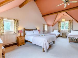 a bedroom with two beds and two windows at The Marle in Hazelwood