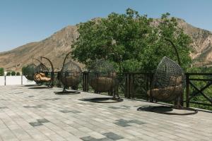 a row of chairs in front of a fence at ARCHAZOR Mountain Resort in Chimgan