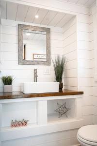 a bathroom with a sink and a mirror at Charming Tiny Home with private deck and bbq in Apple Valley