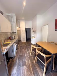 a kitchen with a wooden table and a dining room at Pension Thomas Rooms in Berlin +38 photos