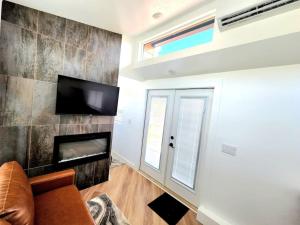 Televiisor ja/või meelelahutuskeskus majutusasutuses Designer Modern Tiny Home w All of The Amenities