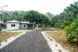 an empty road in front of a house at Adorable 3-bedroom home with Wi-Fi, Netflix and BBQ grill in Rembau