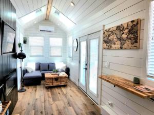 a living room with a couch and a table at NEW Nook Tiny Home with Deck Firepit Skylights in Apple Valley